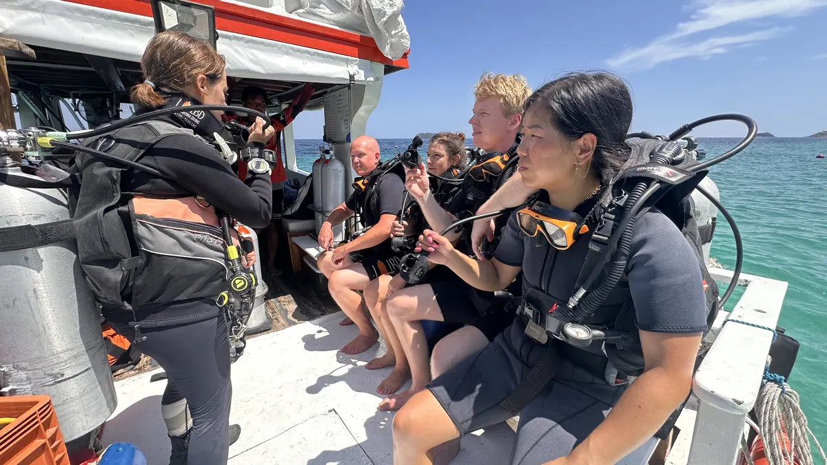 Gearing up on the boat on the way to the dive site